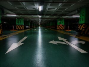 Garage floor showing epoxy and polyurea coating samples beside a prepared concrete slab