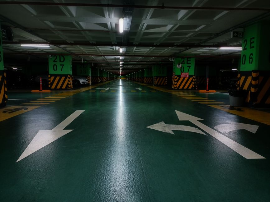 Garage floor showing epoxy and polyurea coating samples beside a prepared concrete slab